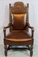 Heavy oak fireside chair with leather upholstery