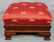 Mahogany Empire footstool with new red upholstery