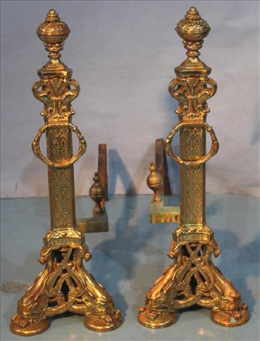Pair of ornate brass andirons w griffin supports: Pair of ornate brass andirons with wing griffin supports