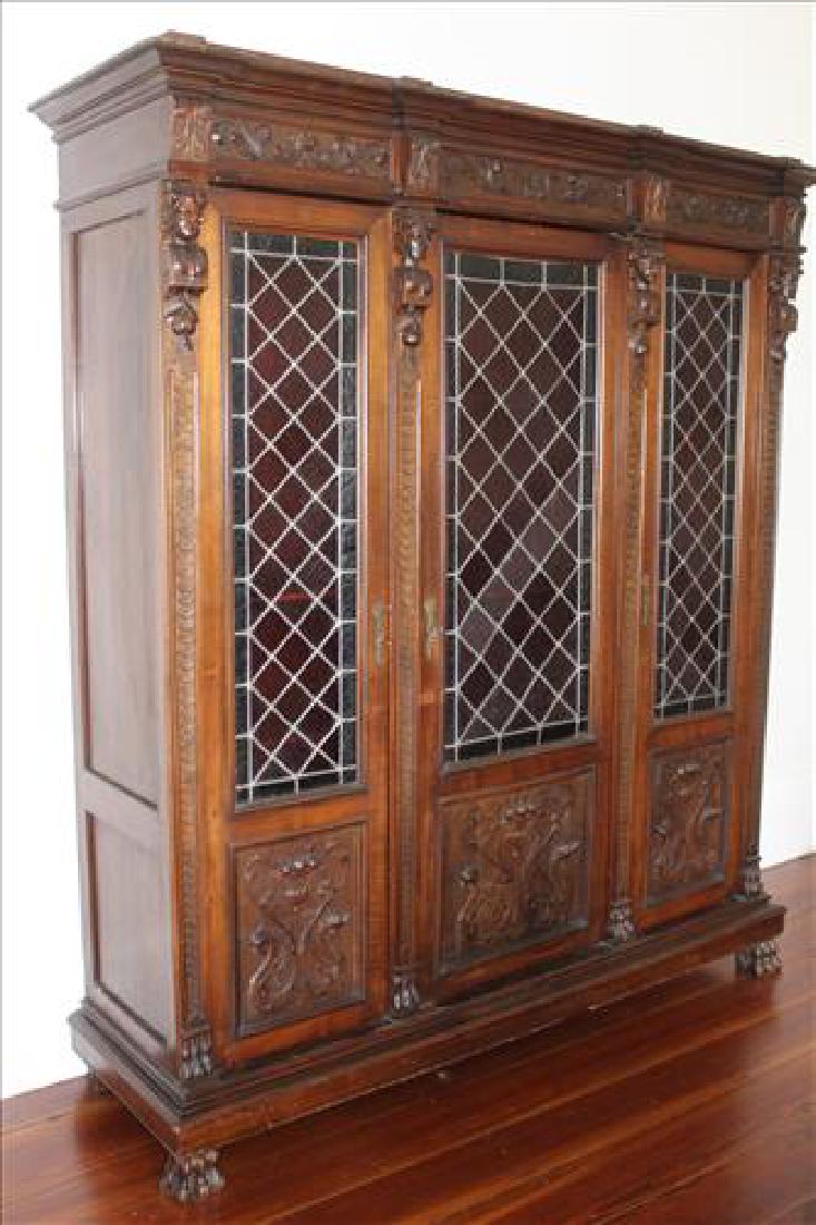 Oak heavily carved 3 door bookcase with glass doors (1 of 5)