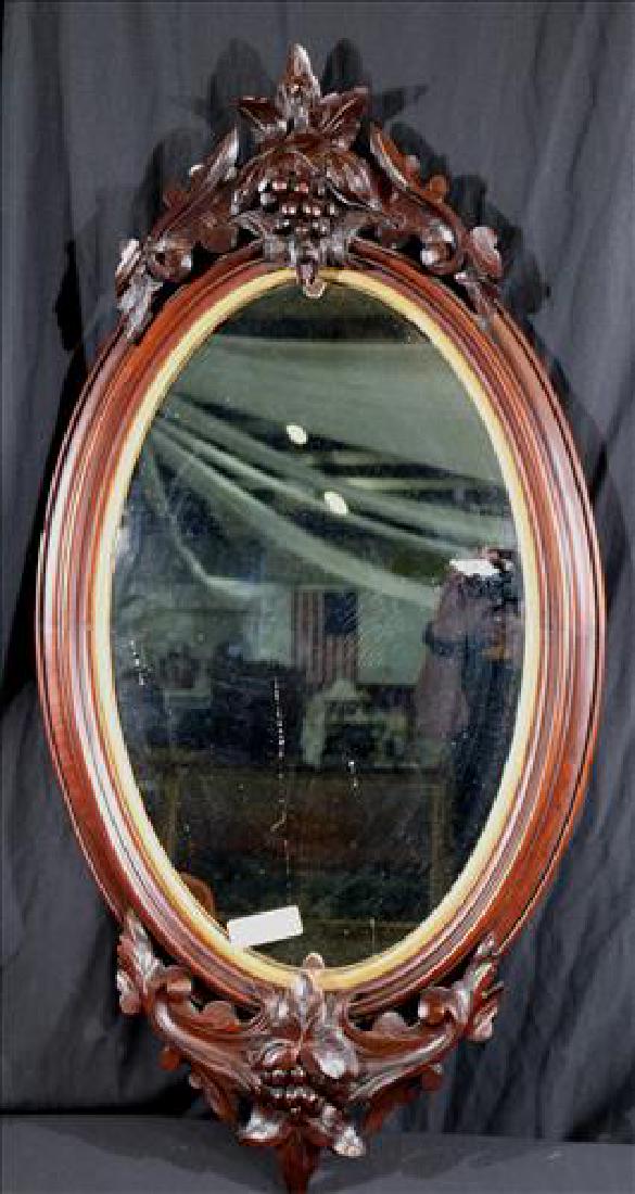 Walnut Victorian oval Victorian mirror with carving