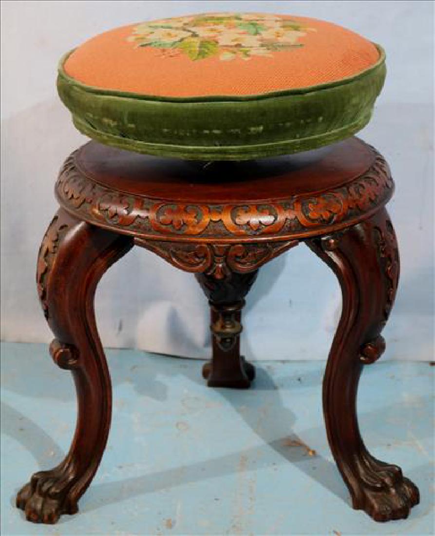 Mahogany Victorian piano stool with needlepoint: Mahogany Victorian piano stool with needlepoint and claw feet, adjustable, 20 in. T, 15 in. Dia.