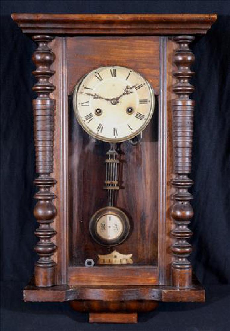 Mahogany wall clock with pendulum and key: Mahogany wall clock with pendulum and key, 24 in. T, 13 in. W, 7 in. D.