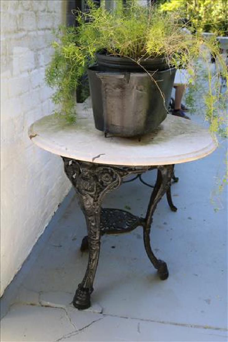 Black cast iron ice cream table with marble top: Black cast iron ice cream table with marble top, signed Westhampton NY, 31 in. T, 29 in. R.