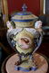 Early pair of capped urns with ladies head, 23 in. T.