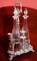 Victorian silver-plate Tantalus set, 3 bottles with