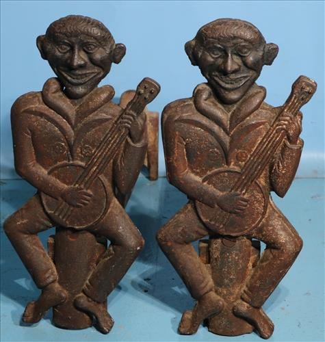 Early cast iron andirons, black figures playing banjo: Early cast iron andirons, black figures playing banjo, 18 in. T, 22 in. L, 9 in. D.