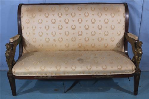 Mahogany sofa with Egyptian winged lions: Mahogany sofa with Egyptian winged lions and beige upholstery, 64 in. L,42 in. T, 20 in. D.