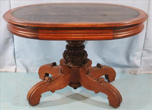 Oval English walnut Victorian table with leather top: Oval English walnut Victorian table with leather top and drawer, 30 in. T, 45 in. W 33 in. D.