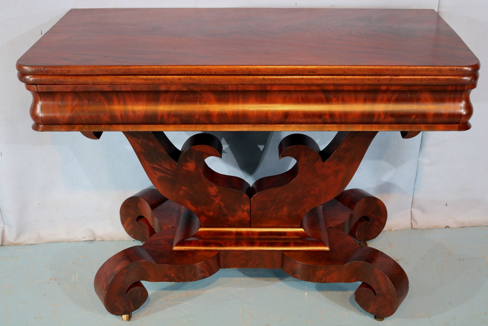 Large Empire game table with scroll feet: Large Empire game table with scroll feet and yolk base, attrib. to Meeks, 30 in. T, 40.5 in. W, 20 in. D.