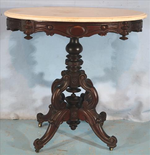 Walnut Victorian oval lamp table with white marble: Walnut Victorian oval lamp table with white marble and lots of carving, 29 in. T, 30 in. W, 22 in. D.