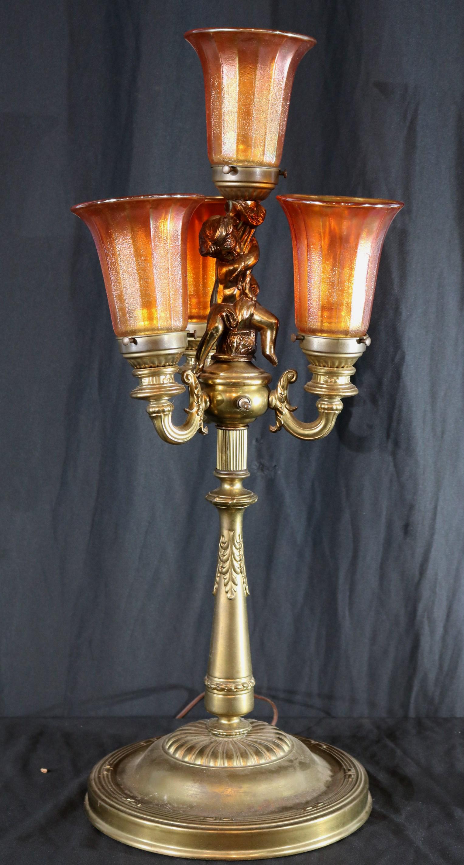 Brass buffet light with cupid and carnival glass: Brass buffet light with cupid and carnival glass shades, 29 in. T, 12 in. W.