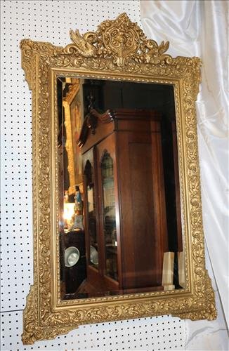 Old gilded Victorian beveled mirror, 47 in. T, 31 in. W: Old gilded Victorian beveled glass mirror, 47 in. T, 31 in. W.
