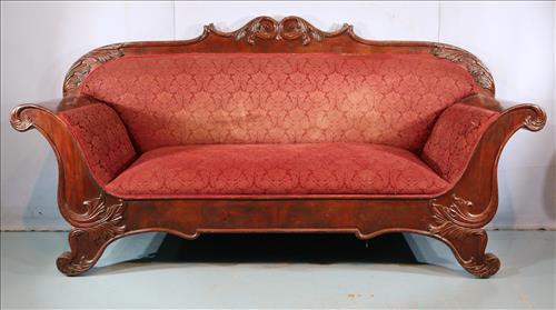 Mahogany Empire sofa with carved back: Mahogany Empire sofa with carved back, wing griffin feet and maroon upholstery, 46 in. T, 87 in. W, 20 in. D.