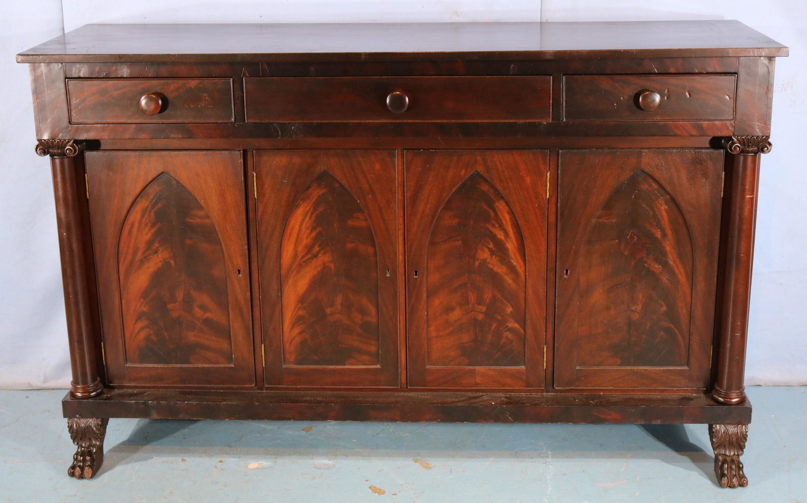 Mahogany Empire sideboard with gothic doors: Mahogany Empire sideboard with gothic doors, claw feet and column front, 44 in T, 72 in. L, 23 in. D.