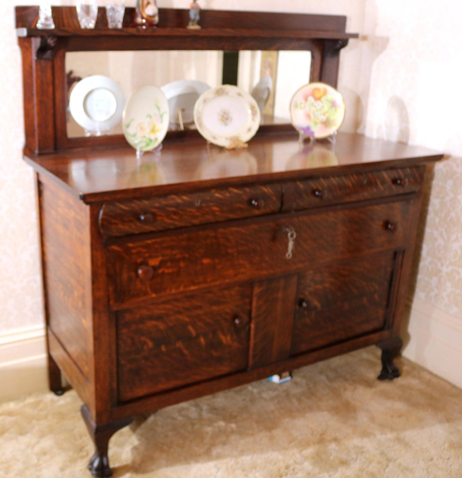 Mission oak sideboard with blacksplash: Mission oak sideboard with mirror blacksplash, 3 drawers, 2 doors and original wood pulls, 56 in. T, 40 in. W, 23 in. D.