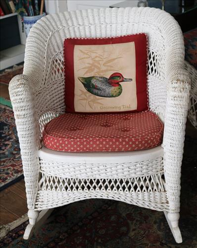 White wicker rocker: White wicker rocker, 31 in. T, 27 in. W, 20 in. D.