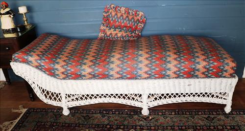 Antique wicker chaise lounge: Antique wicker chaise lounge with new upholstery, 25 in. T, 73 in. L, 25 in. D.