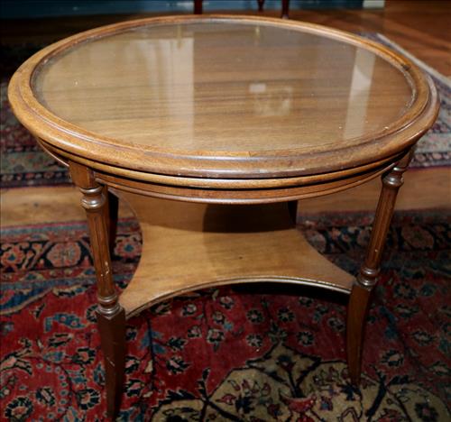 Mahogany round glass top tea table: Mahogany round glass top tea table, 20 in. T, 25 in. D.