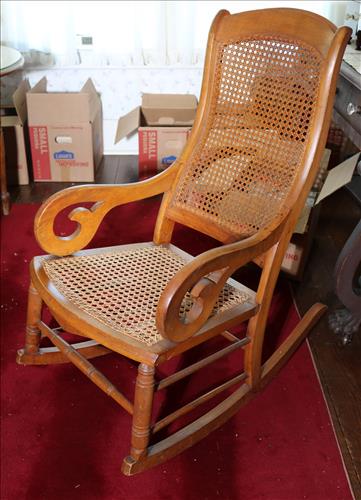 Walnut gooseneck rocker with lace cane back: Walnut gooseneck rocker with lace cane back, 39 in. T, 21 in. W, 19 In. D.