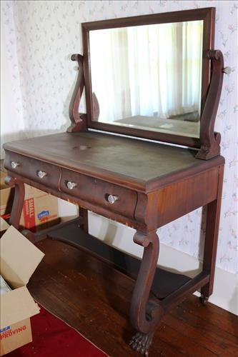 Mahogany Empire 2 drawer vanity: Mahogany Empire 2 drawer vanity with original pulls, curved front and claw feet, 58 in T, 42 in. W, 22.5 in. D., small damage