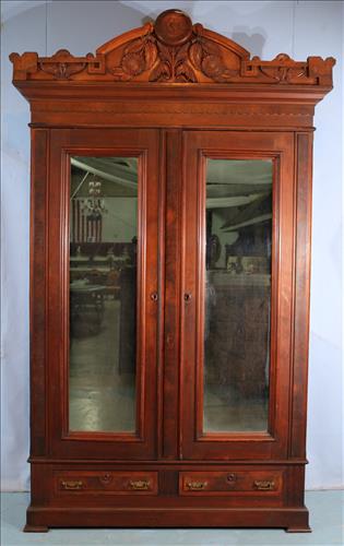 Walnut Victorian 2 door wardrobe with crown: Walnut Victorian 2 door wardrobe with Birdseye interior, heavily carved crown and 2 drawers in bottom, matches #70 bed, 8 ft. 5 in. T, 5 ft. W, 20 in. D., originally from Riverview, ca. 1850