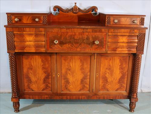 Mahogany Empire sideboard with twisted column front: Mahogany Empire sideboard with twisted column front and 5 drawers over 3 doors, in good condition signed Williams & Kimp, Grand Rapids, MI, 51 in. T. 60 in. W, 22 in. D.