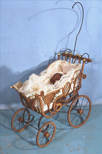 Antique wicker baby buggy, 27 in. T, 29 in. T, 12 in.: Antique wicker baby buggy, 27 in. T, 29 in. T, 12 in. D.
