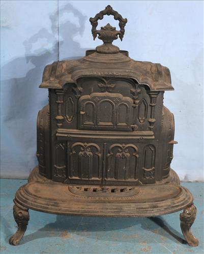 Victorian cast iron parlor stove: Victorian cast iron parlor stove made by the Chamberlain Company, Cincinnati, OH, 36 in. T, 29 in. W, 19 in. D.