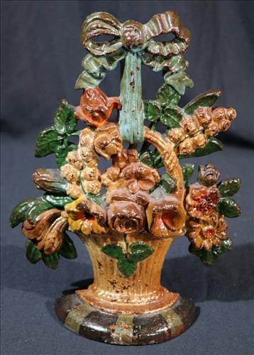 Banquet of flowers cast iron door stop: Banquet of flowers cast iron door stop, not old, 10 in. T, 7.5 in. W.