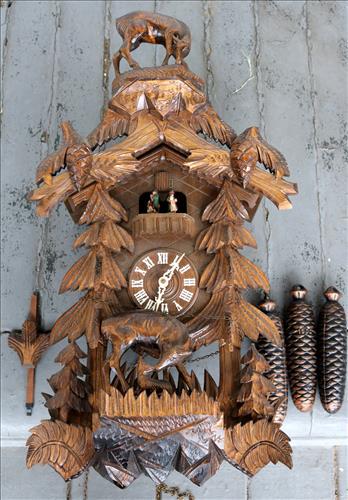 Lg. wood cuckoo clock with weights, pendulum: Lg. wood cuckoo clock with weights and pendulum, 25.5 in. T, 14.5 in. W, 8.5 in. D.