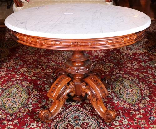 Walnut Victorian center table by Thomas Brooks: Walnut Victorian center table by Thomas Brooks with original white marble top, 31 in. T, 41 in. W, 32 in. D.