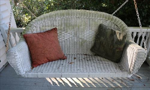 Antique white Wicker porch swing: Antique white Wicker porch swing w/ chains for hanging. Needs restoration 25.5T, 54W, 21D