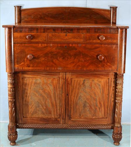 Flame mahogany Empire Jackson press: Flame mahogany Empire Jackson press with acanthus carved column front and backsplash, 61.5 in. T, 51 in. W, 23.5 in. D.