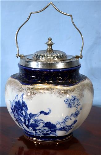 Flow blue biscuit jar with silver plate rim: Flow blue biscuit jar with silver plate rim, 9.5 in. T, 6.5 in. Dia.