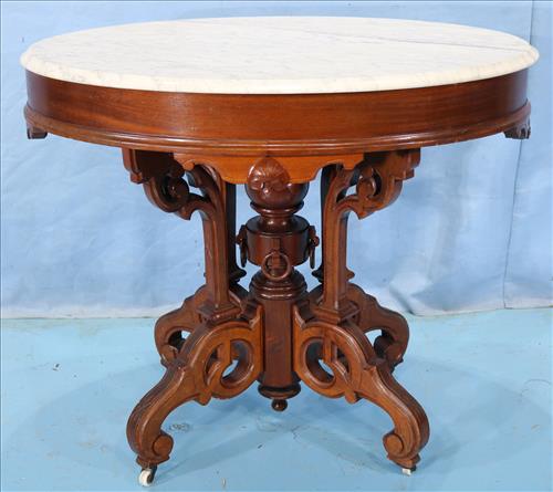 Walnut Victorian oval center table with marble: Walnut Victorian oval center table with marble top and beautiful base attrib. to Thomas Brooks, 30 in. T, 35.5 in. W, 25.5 in. D.