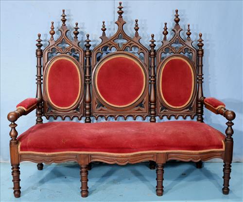 Triple seated gothic walnut hall seat: Triple seated gothic walnut hall seat with turned legs and pierced carved back, 55 in. T, 63 in. W, 22 in. D.