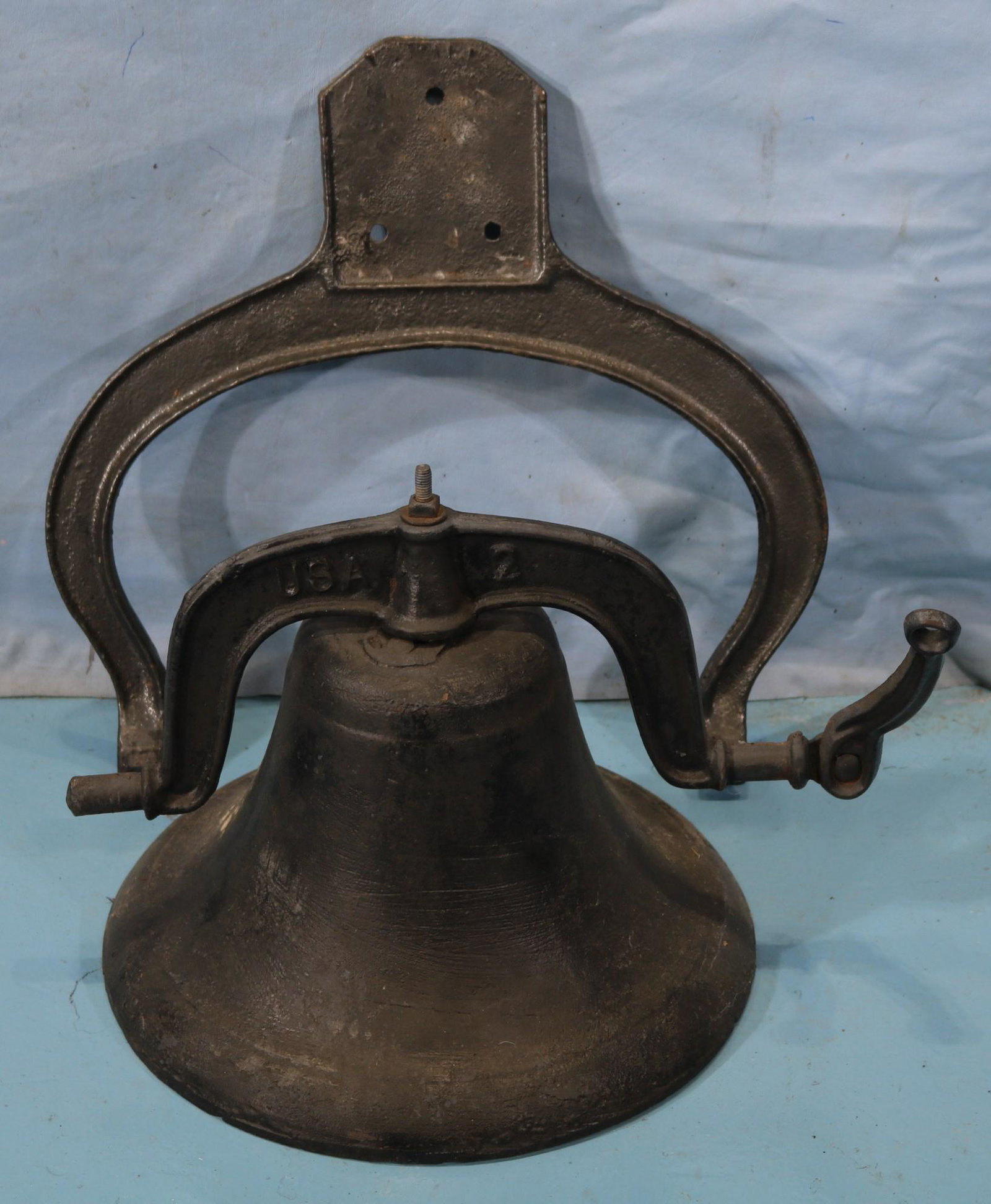 Old cast iron bell with yolk and strikers # 2: Old very heavy cast iron bell with yolk and strikers # 2, in good condition, 19 in. T, 20 in. W, 16 in. Dia.