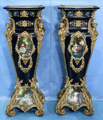 Pair of rococo French pedestals, black and gold: Stunning pair of rococo French pedestals, black and gold with scenes painted on transfer plates, gold bust figures on each corner and gold C scroll feet, 49 in. T, 17 in. Sq. Condition is excellent an