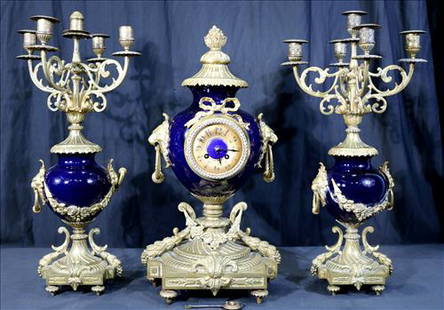 3 Piece French clock set in porcelain and bronze: 3 Piece French clock set with 2 candelabras in blue porcelain and bronze, 22 in. T, 11 in. W, 10 in. D.