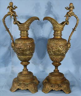 Pair of Victorian bronze ewers with cupids, 25 in. T.: Pair of Victorian bronze ewers, very decorated with cupid on handles, 25 in. T, 12 in. W.