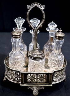 Victorian silver-plate cruet set with 6 bottles: Original Victorian silver-plate 6 bottle cruet set, 3 with stoppers, 1 bottle has small chip, 11 in. T, 9 in. W.