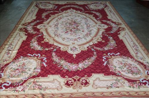 French needlepoint rug, 8 ft. 11 in. x 13 ft. 9 in.: French needlepoint highly decorated rug with center medallion, wine, gold and pink, 8 ft. 11 in. x 13 ft. 9 in.