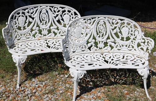 Pair of cast iron garden love seats, 32 in. W.: Pair of cast iron garden love seats, 32 in. W. 26 in. T, 13 in. D.