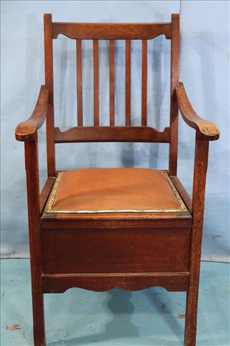 Mahogany potty chair with lift seat and porcelain pot: Mahogany potty chair with lift seat and porcelain pot insert, 41 in. T, 21 in. W, 18 in. D.