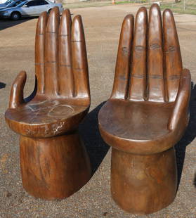 Pair of solid teakwood hand shape chairs: Pair of solid teakwood hand shape chairs, very comfortable, 19 in. T, 22 in. W, 17 in. D.
