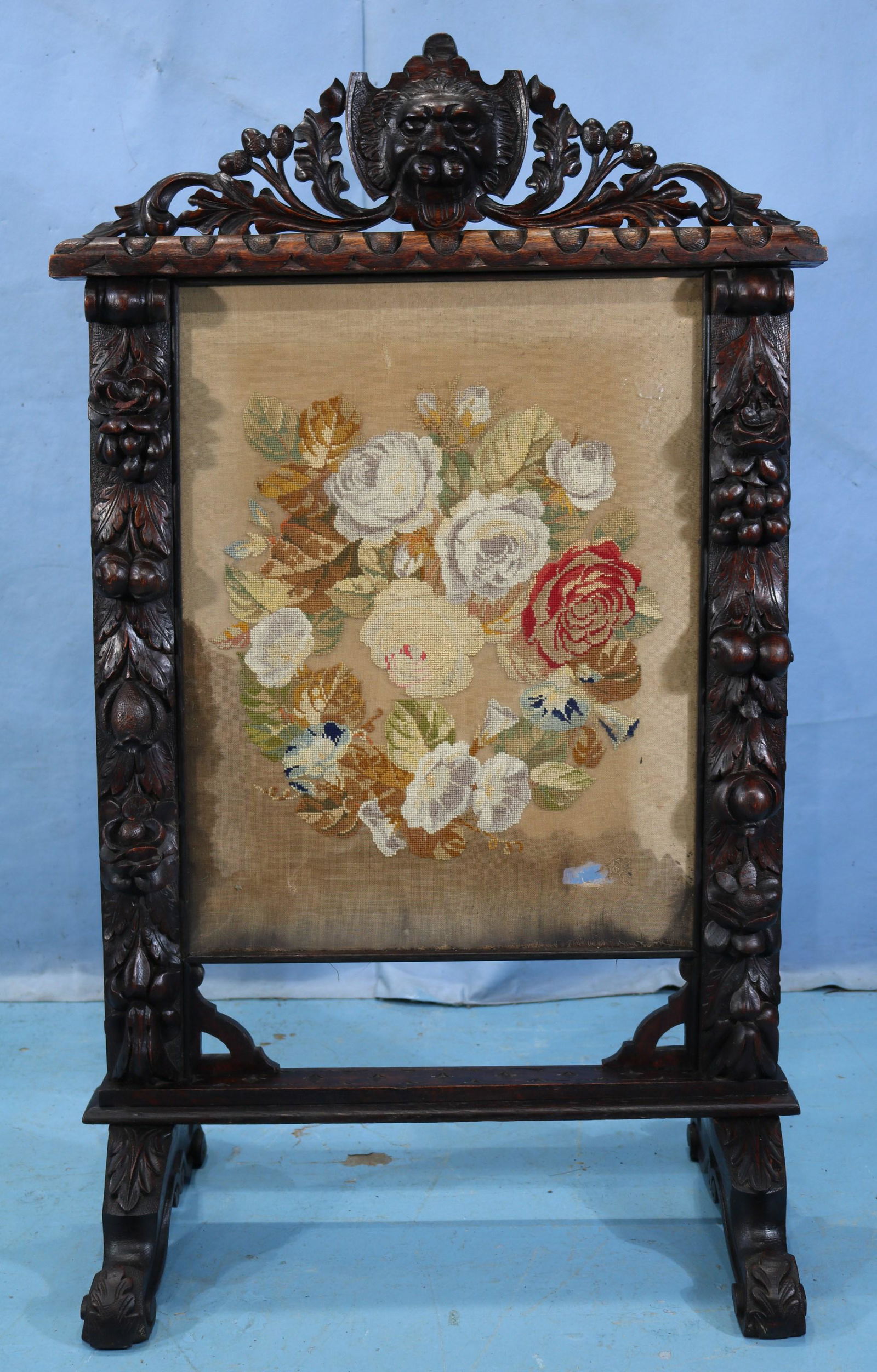 Heavily carved oak fire screen with face crown (1 of 8)