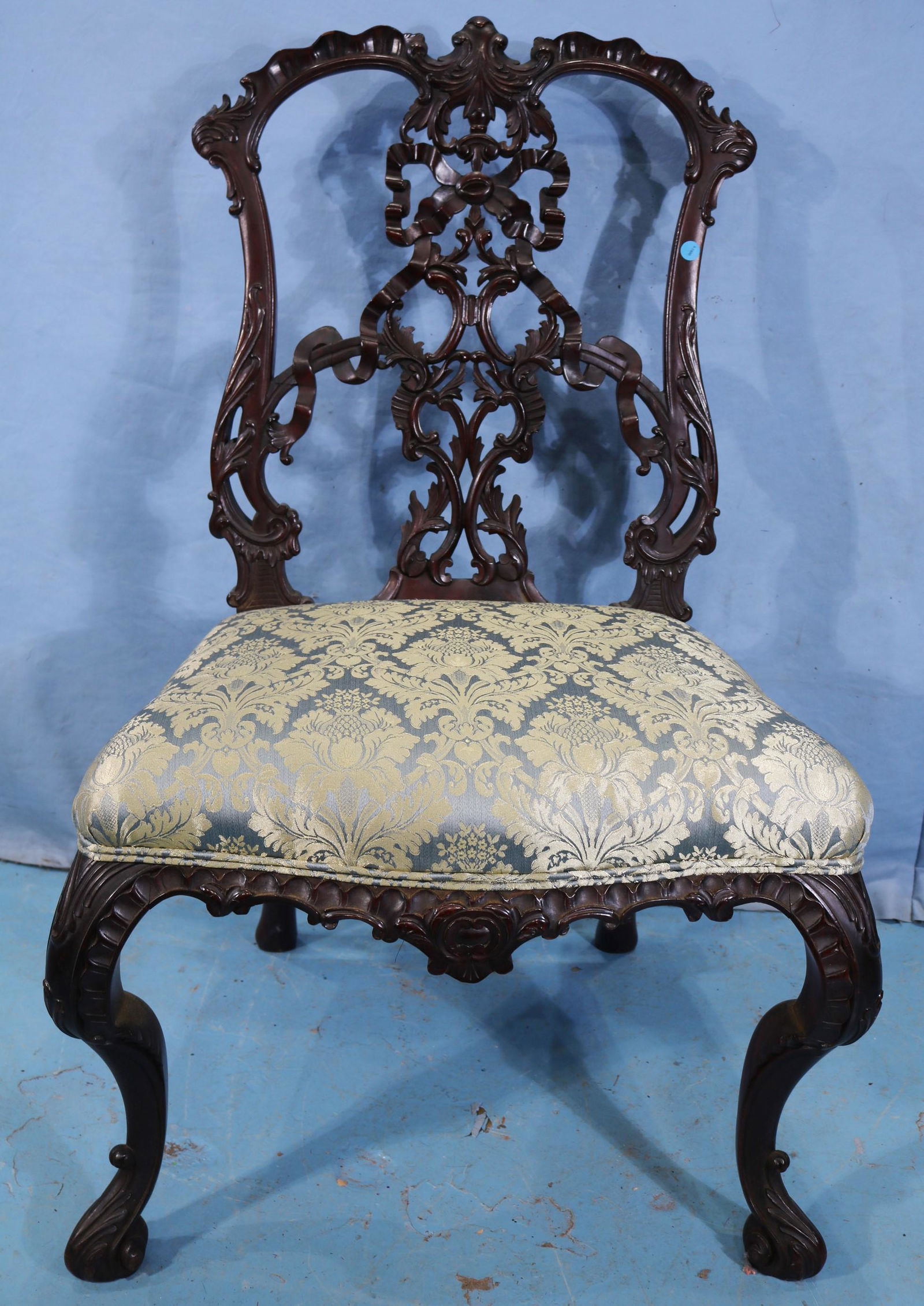 Mahogany Irish Chippendale dining chair: Mahogany Irish Chippendale dining chair with ribbon carved back and green upholstery, 40 in. T, 36 in. W, 18 in. D.