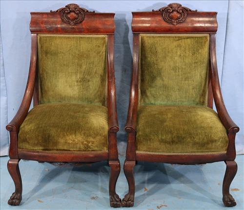 Pair of heavy oak hip rest parlor chairs with crown: Pair of heavy oak hip rest parlor chairs with carved crown and green upholstery, 39 in. T, 32 in. W, 22 in. D.