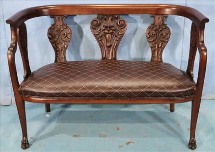 Mahogany love seat with heavily carved back: Mahogany love seat with heavily carved back in mint condition, 32 in. T, 44 in. W, 20 in. D.